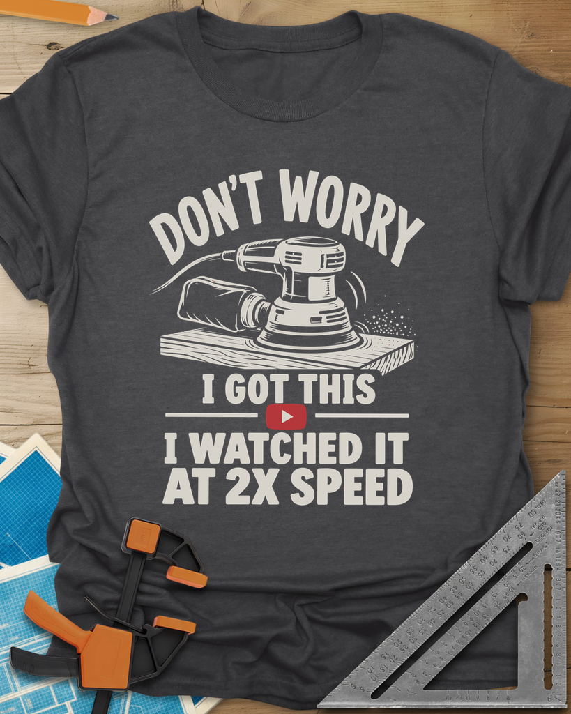 2x Speed t-shirt in Dark Heather Grey, an orbital sander on a board beside a red video play button