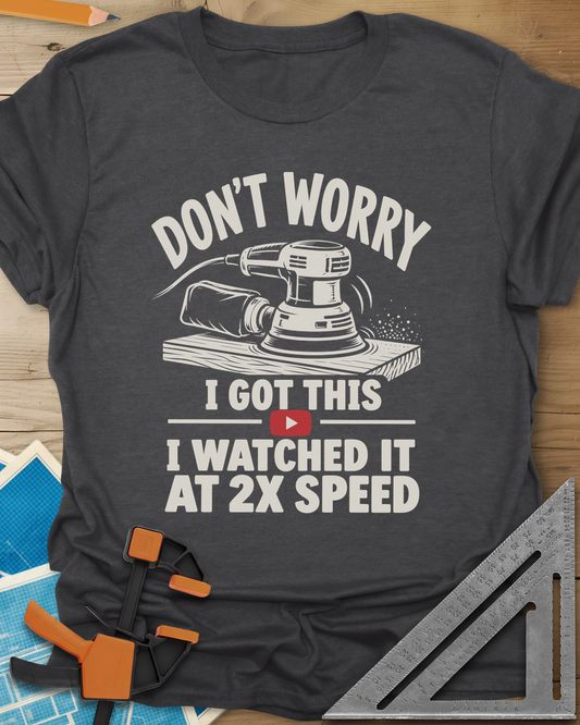 2x Speed t-shirt in Dark Heather Grey, an orbital sander on a board beside a red video play button