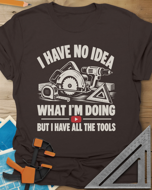 All The Tools t-shirt in Dark Chocolate, circular saw, drill, tape measure and square above a play button