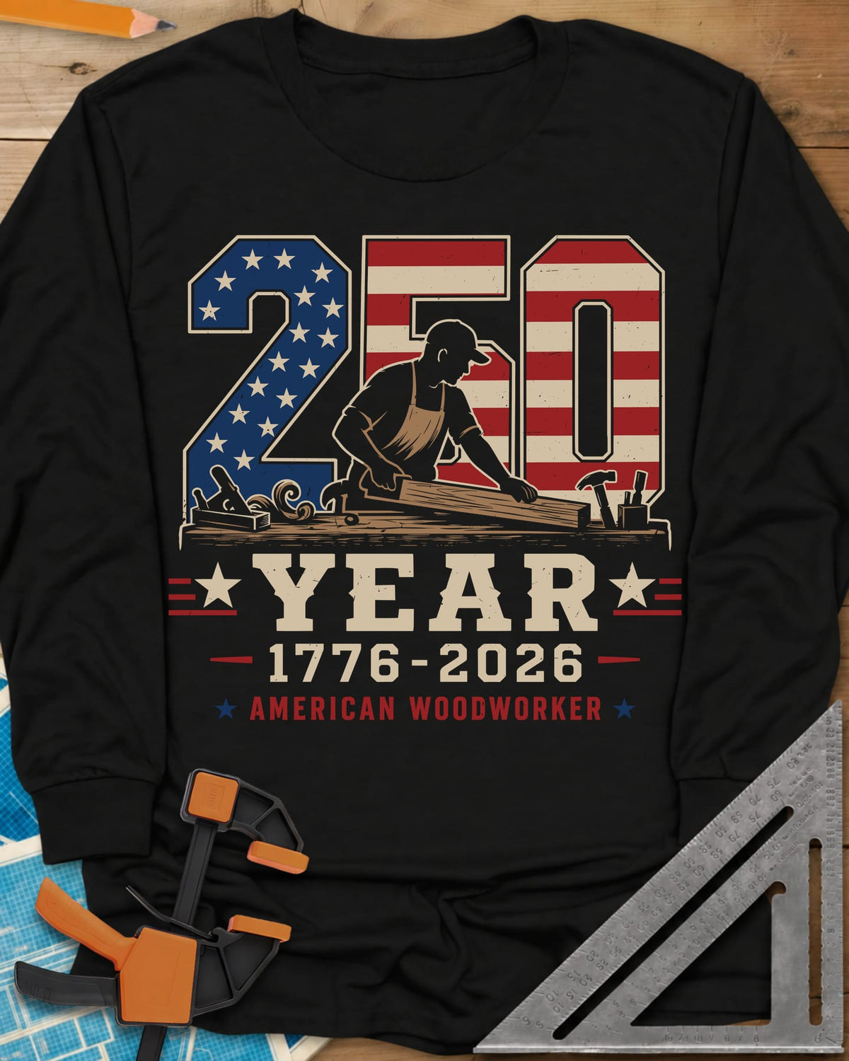 250 Year American Woodworker long sleeve shirt in Black, stars-and-stripes 250 with a woodworker planing a board