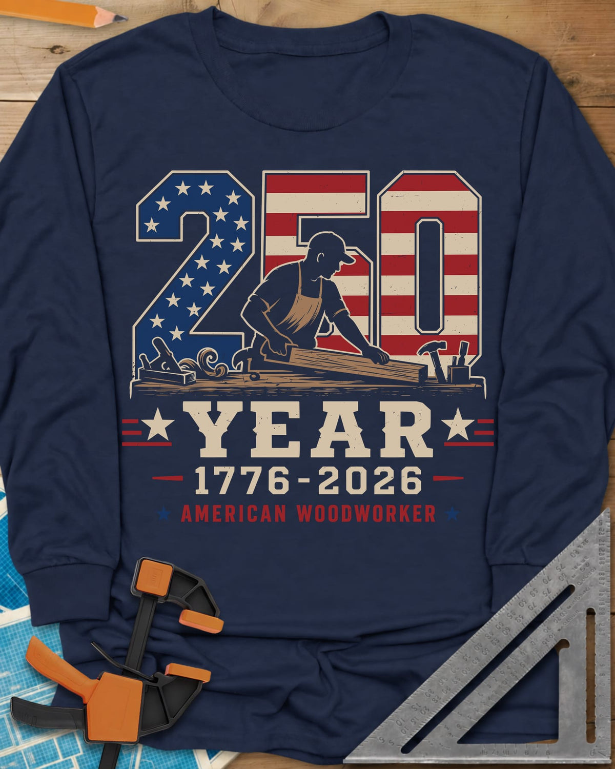 250 Year American Woodworker long sleeve shirt in Navy, stars-and-stripes 250 with a woodworker planing a board
