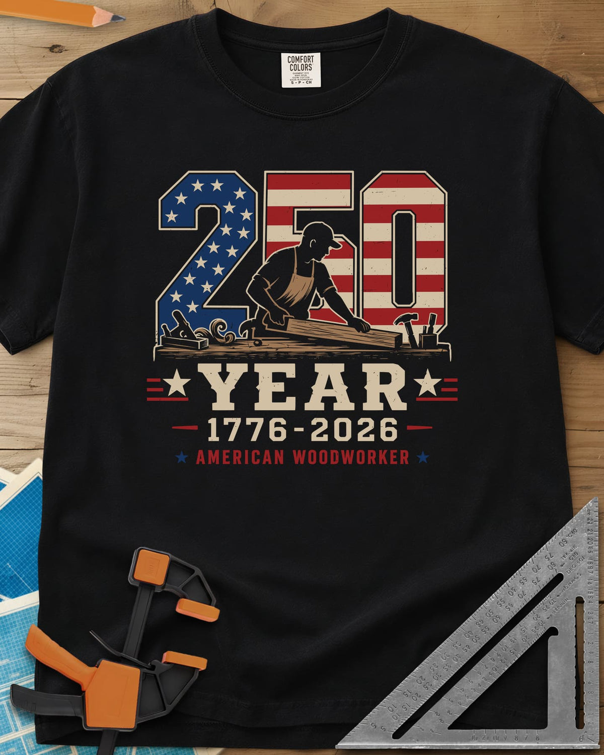 250 Year American Woodworker heavyweight tee in Black, stars-and-stripes 250 with a woodworker planing a board
