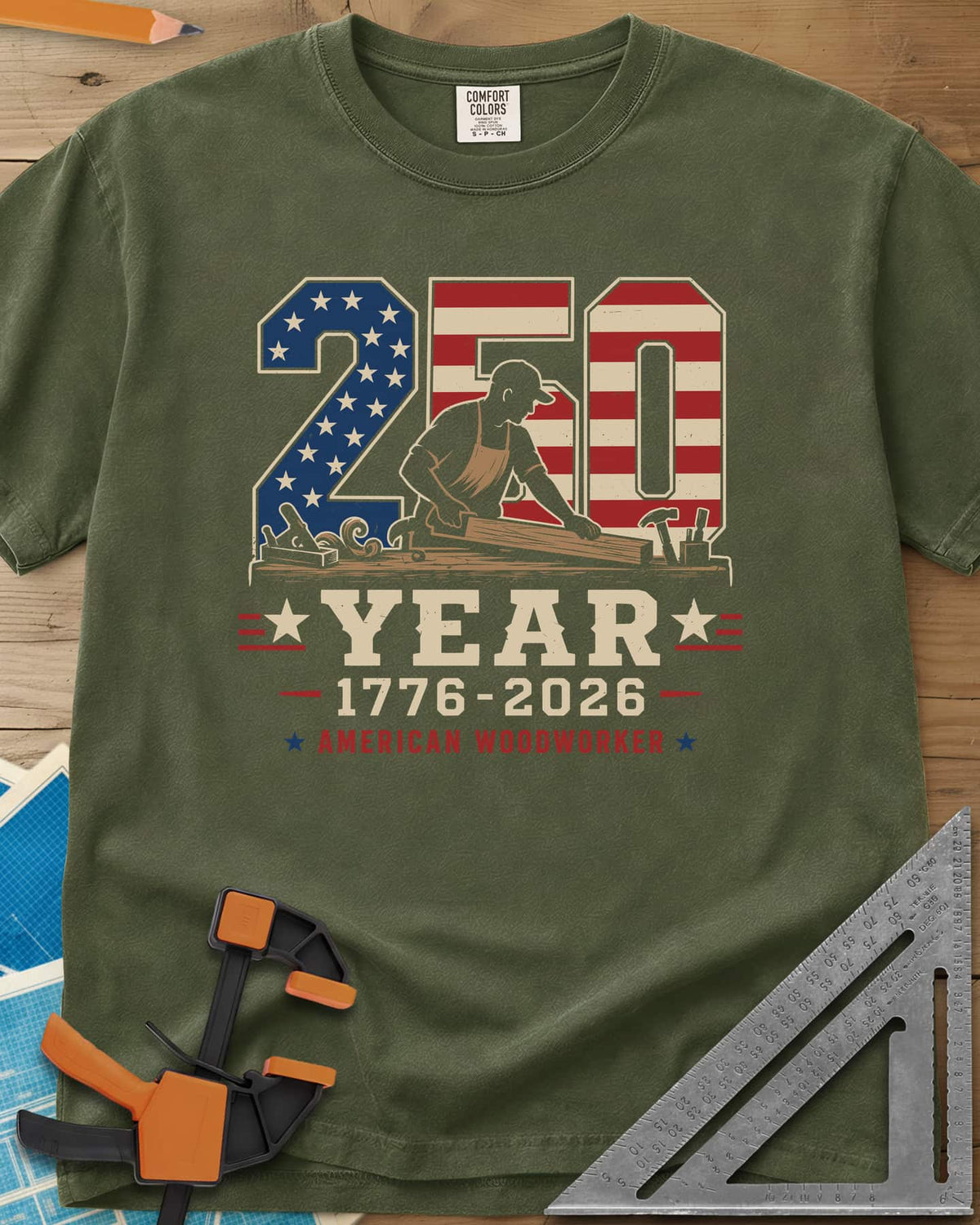 250 Year American Woodworker heavyweight tee in Hemp, stars-and-stripes 250 with a woodworker planing a board