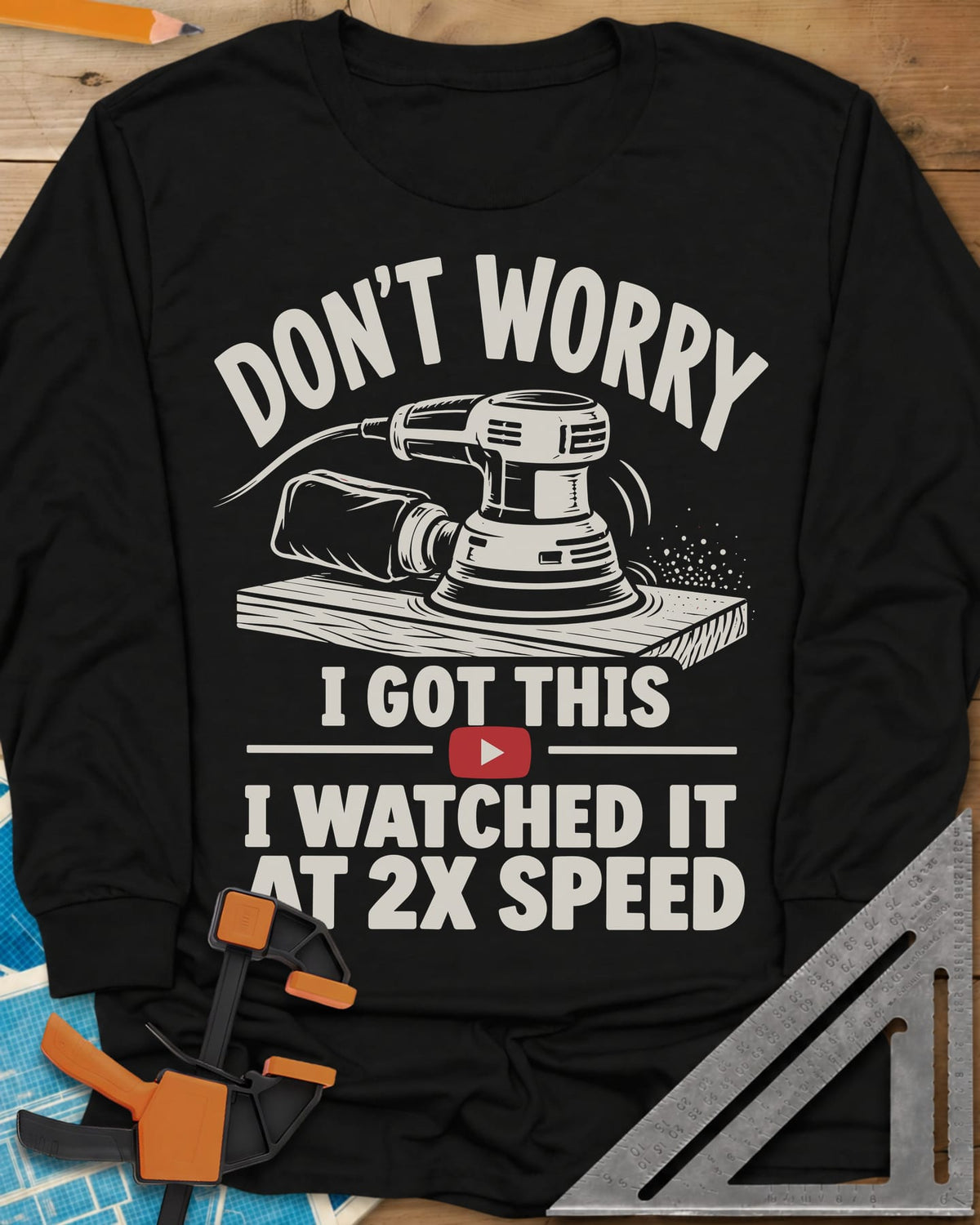 2x Speed long sleeve shirt in Black, an orbital sander on a board beside a red video play button