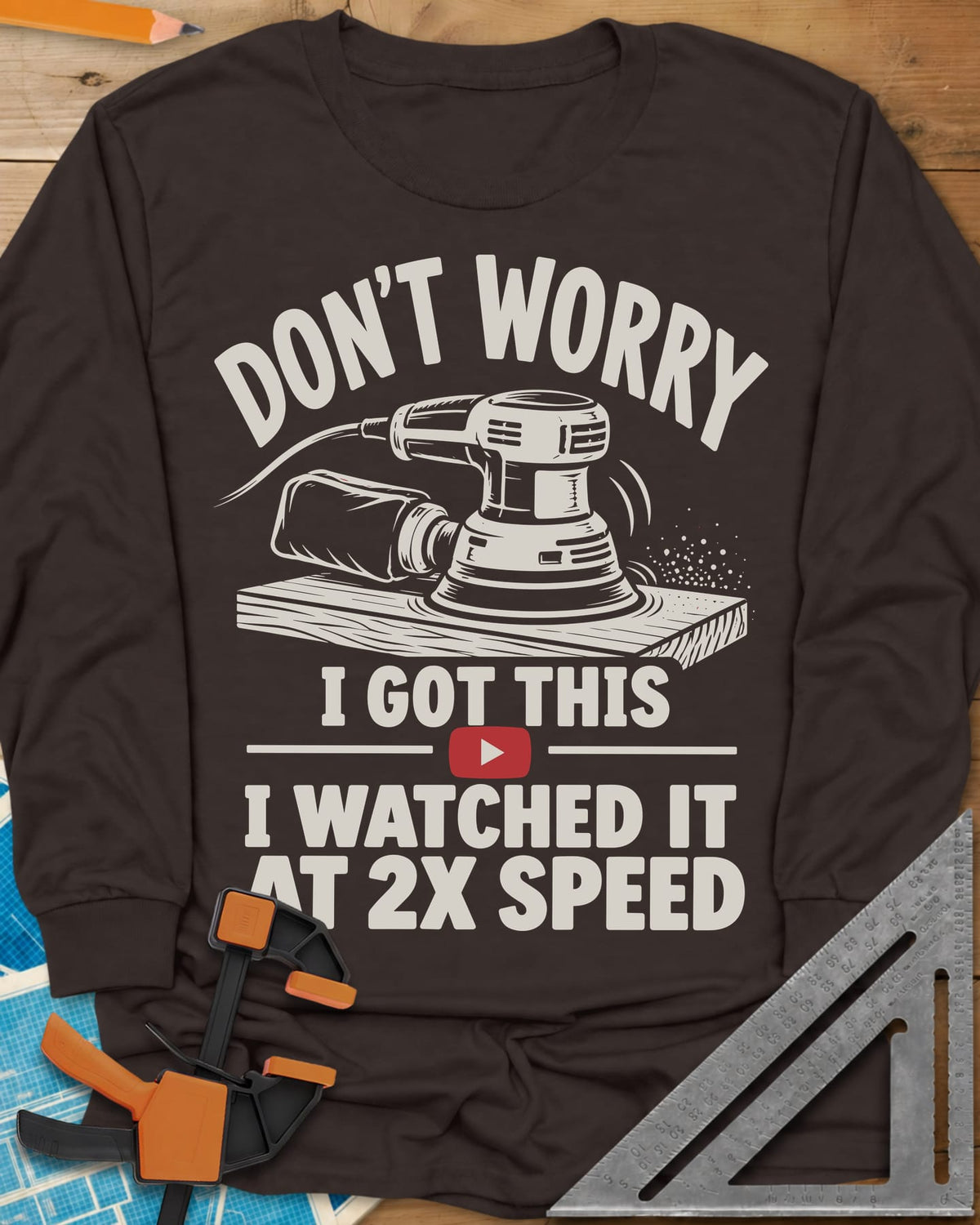 2x Speed long sleeve shirt in Dark Chocolate, an orbital sander on a board beside a red video play button