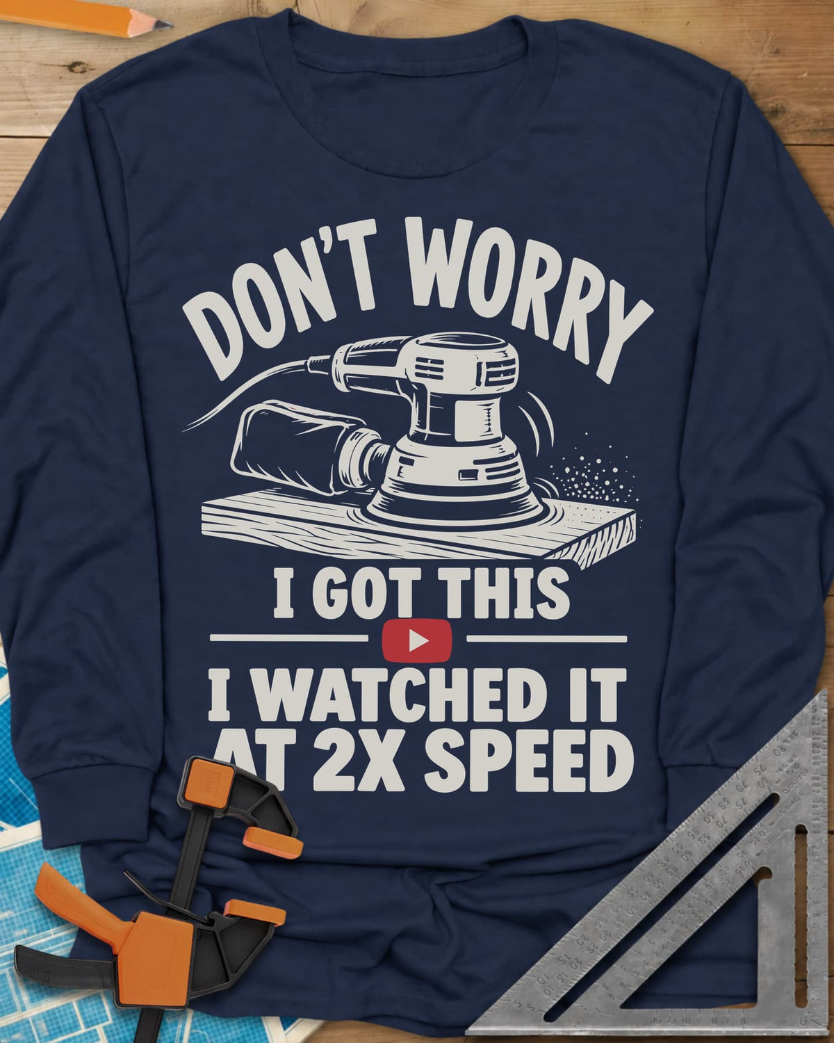 2x Speed long sleeve shirt in Navy, an orbital sander on a board beside a red video play button
