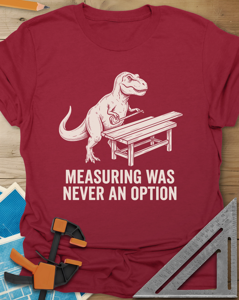 Dino Measuring t-shirt in Cardinal Red, a T. rex with a tape measure beside a plank workbench