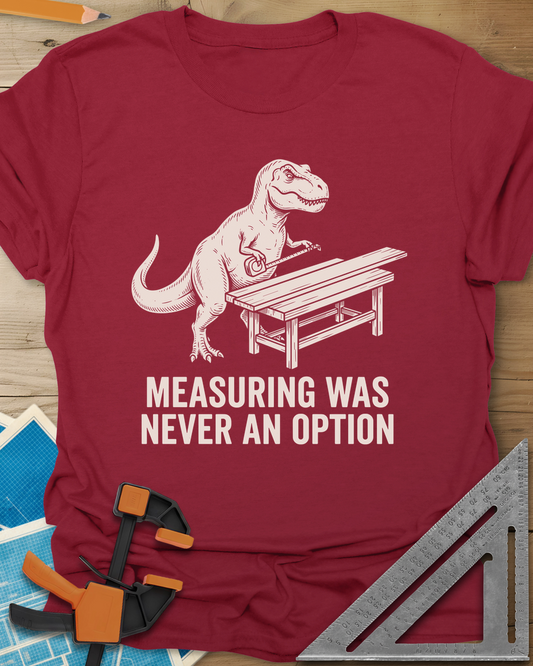 Dino Measuring t-shirt in Cardinal Red, a T. rex with a tape measure beside a plank workbench