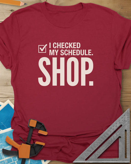I Checked My Schedule Shop t-shirt in Cardinal Red, a checked box beside small text and a huge SHOP below
