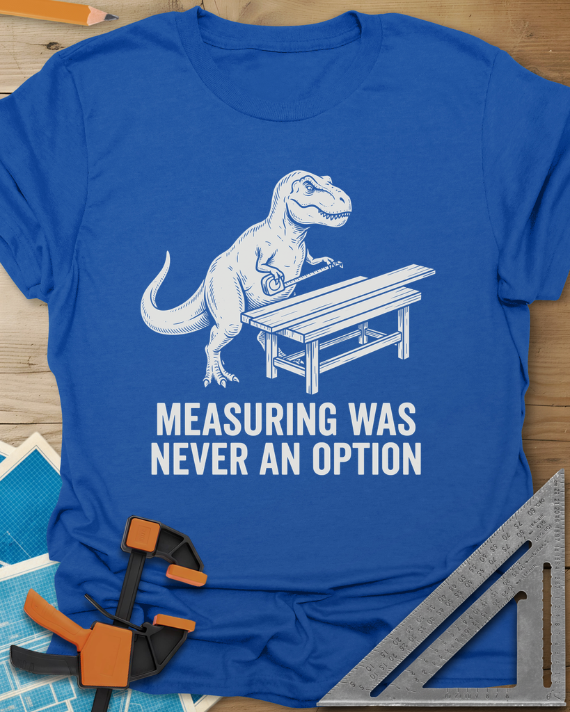Dino Measuring t-shirt in Royal, a T. rex with a tape measure beside a plank workbench