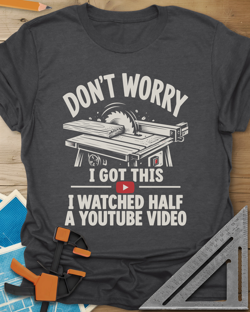 YouTube Video t-shirt in Dark Heather Grey, a table saw with a board at the blade above a red play button