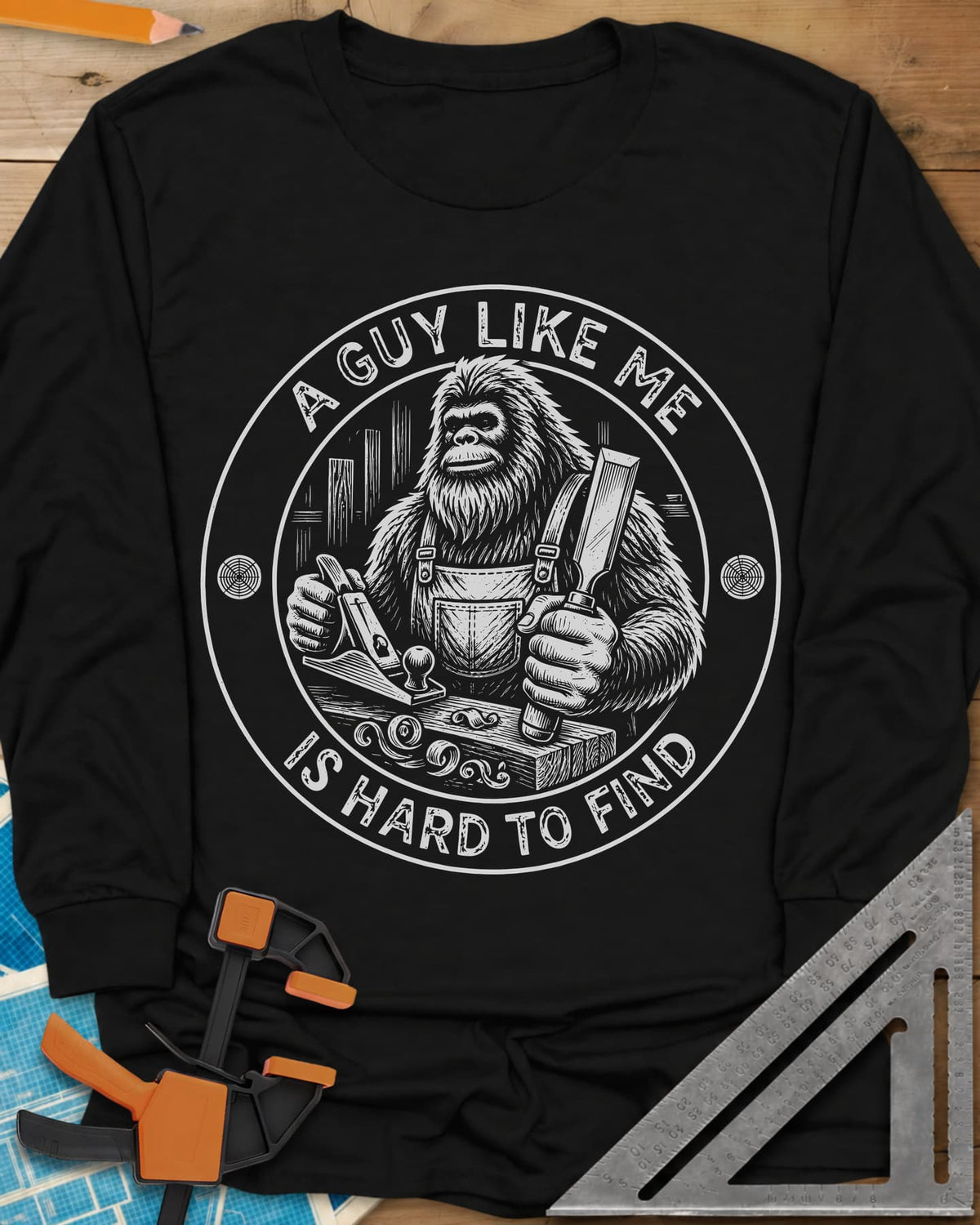 A Guy Like Me Is Hard To Find Woodworking long sleeve shirt in Black, Bigfoot in overalls with a hand plane and chisel