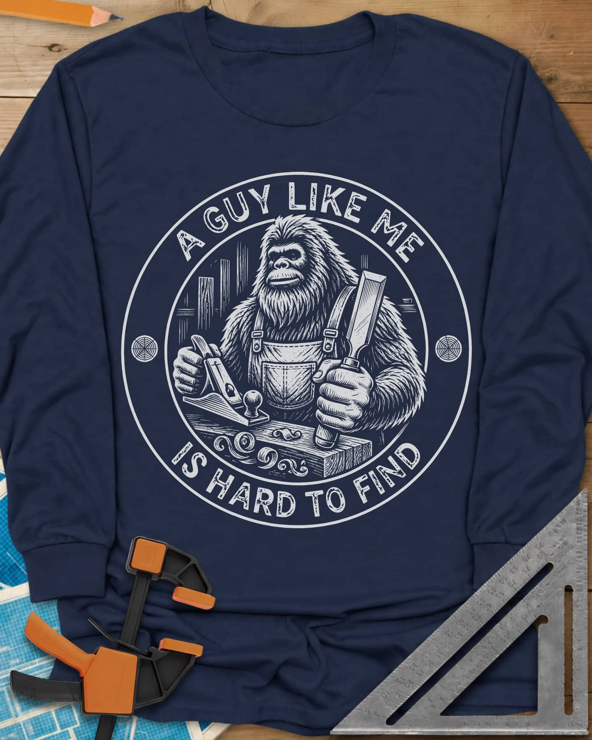 A Guy Like Me Is Hard To Find Woodworking long sleeve shirt in Navy, Bigfoot in overalls with a hand plane and chisel inside