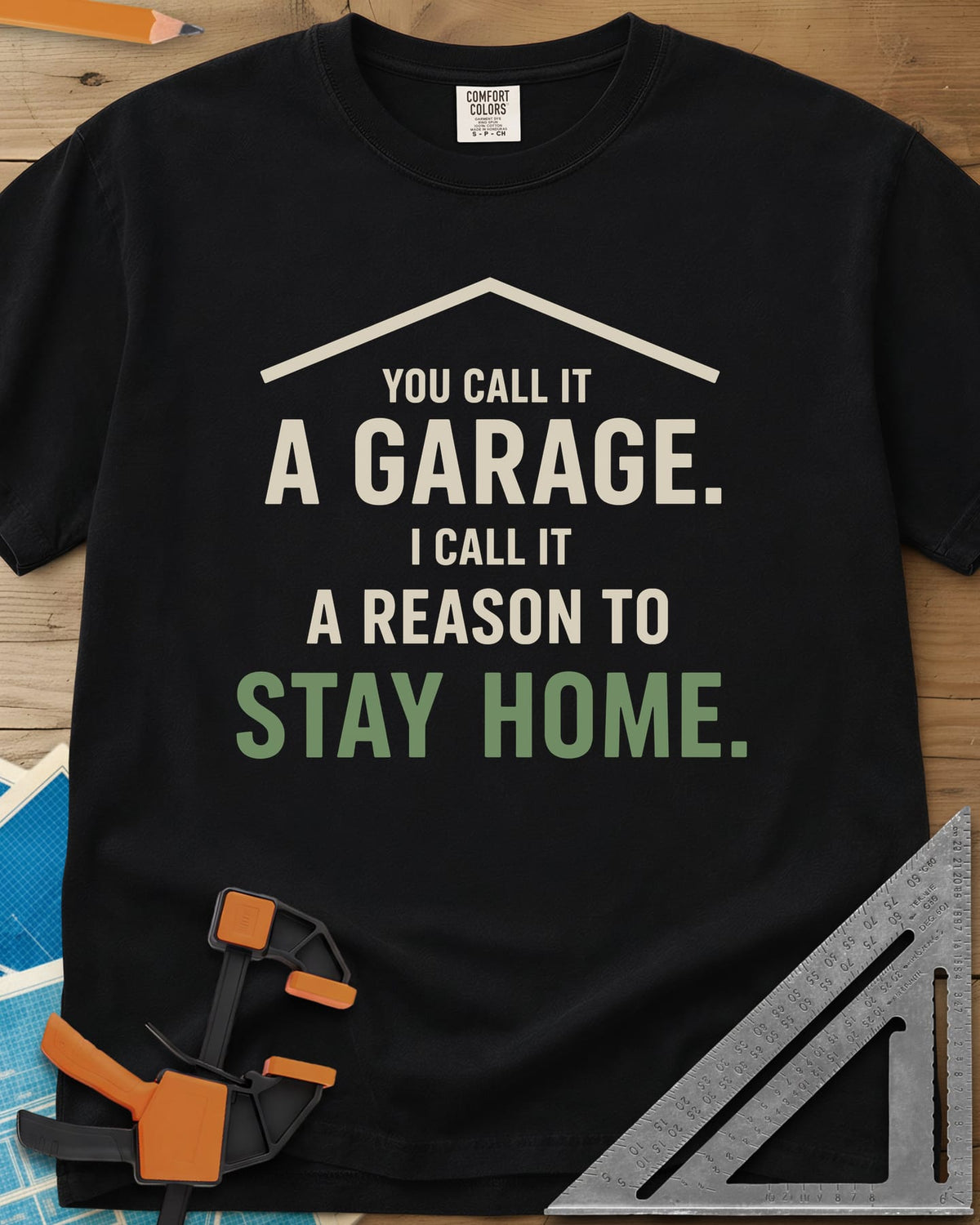 A Reason To Stay Home heavyweight tee in Black, a simple roofline above bold two-tone lettering