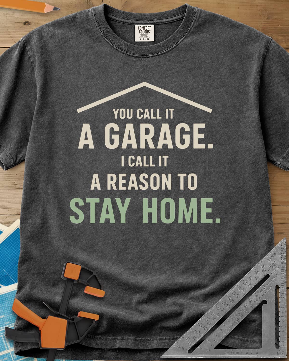 A Reason To Stay Home heavyweight tee in Pepper, a simple roofline above bold two-tone lettering