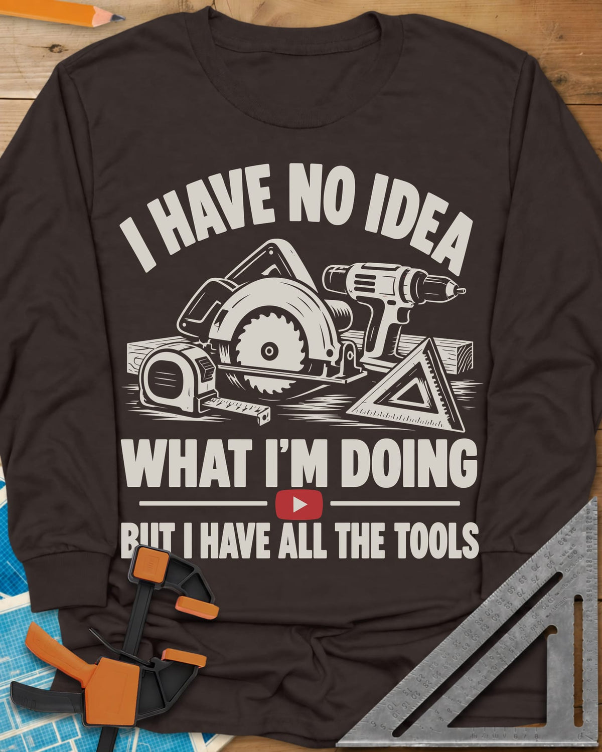 All The Tools long sleeve shirt in Dark Chocolate, circular saw, drill, tape measure and square above a play button