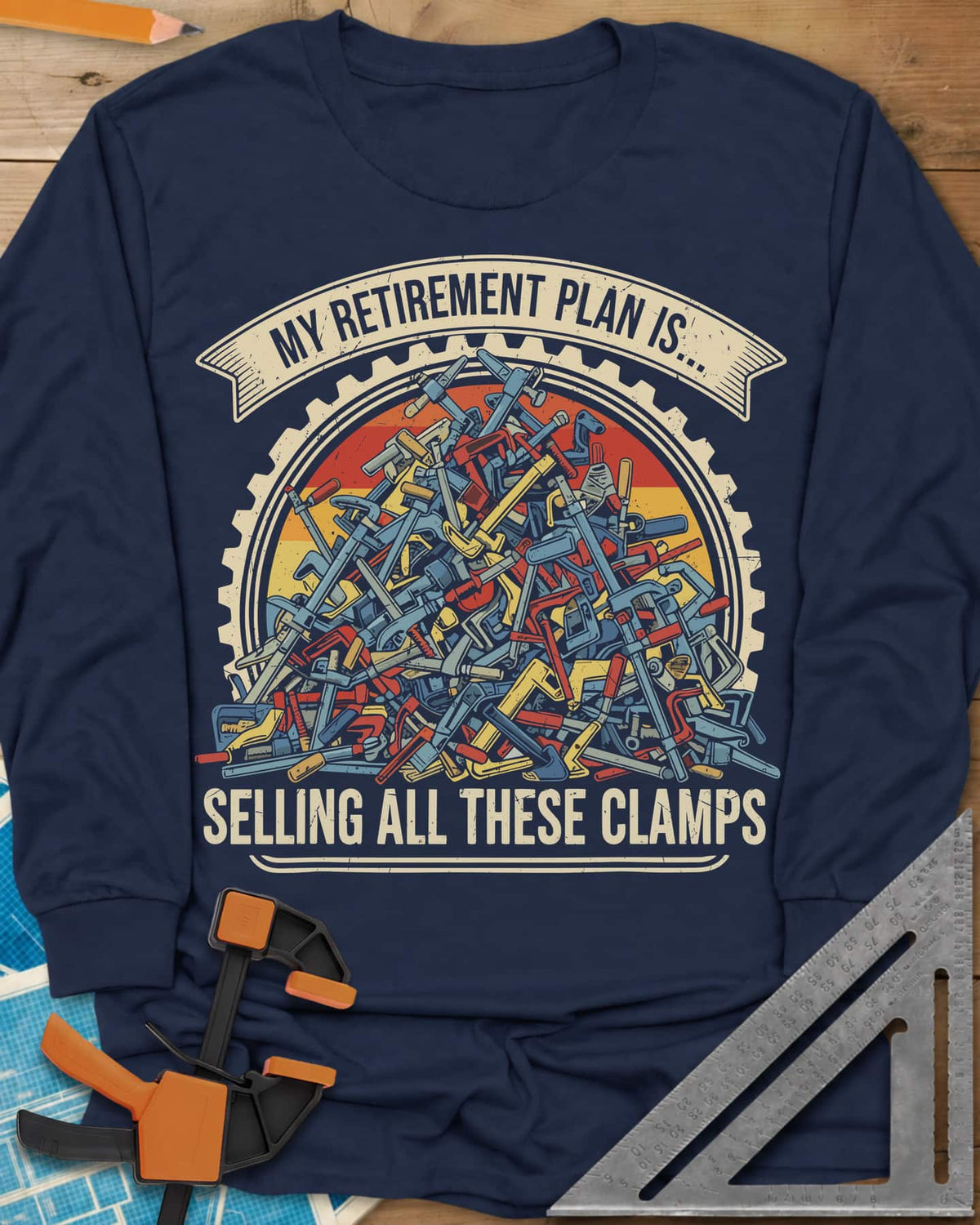 All These Clamps long sleeve shirt in Navy, a heap of colorful clamps in a cog ring with a retro sun