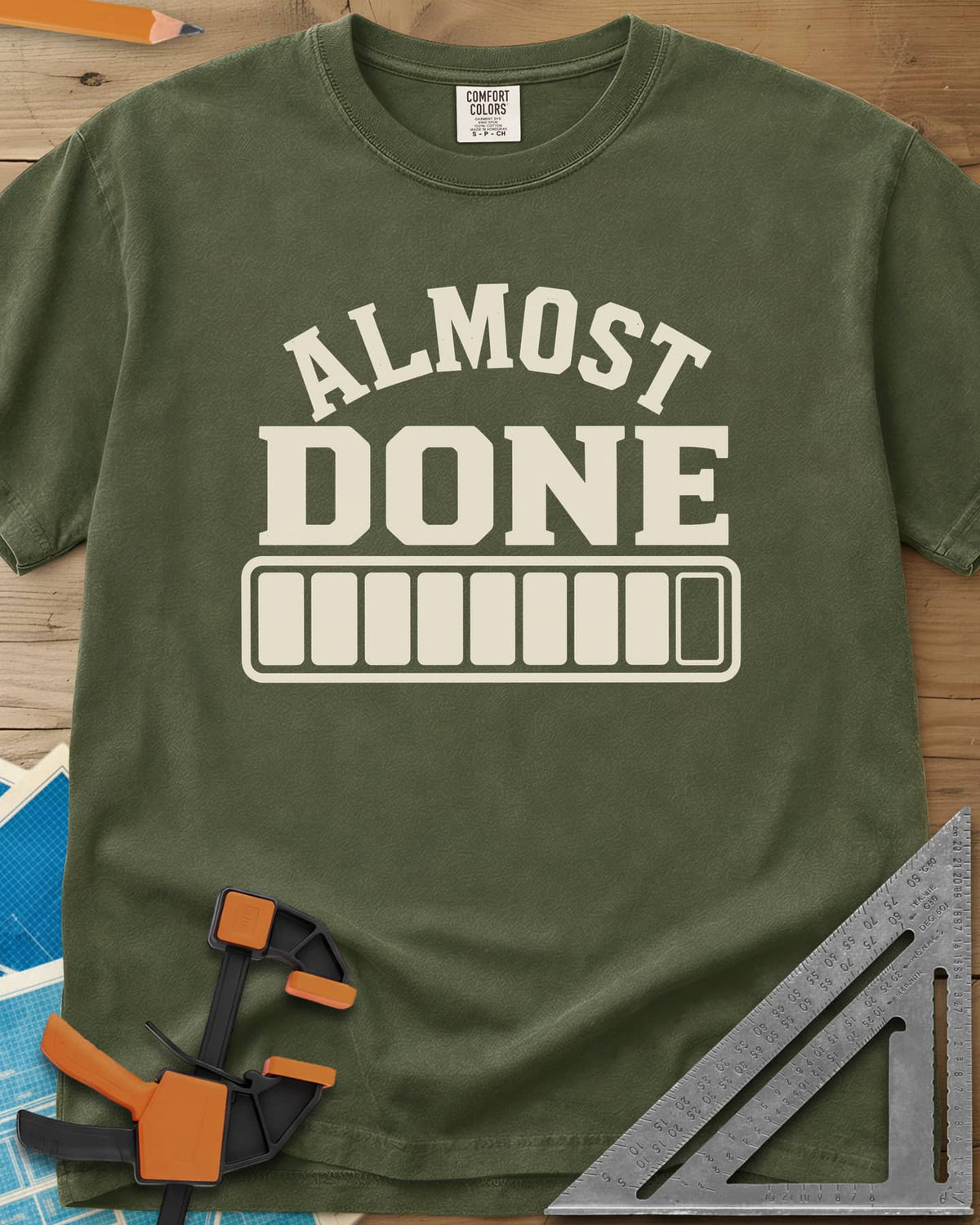 Almost Done heavyweight tee in Hemp, bold ALMOST DONE lettering over a nearly full loading bar