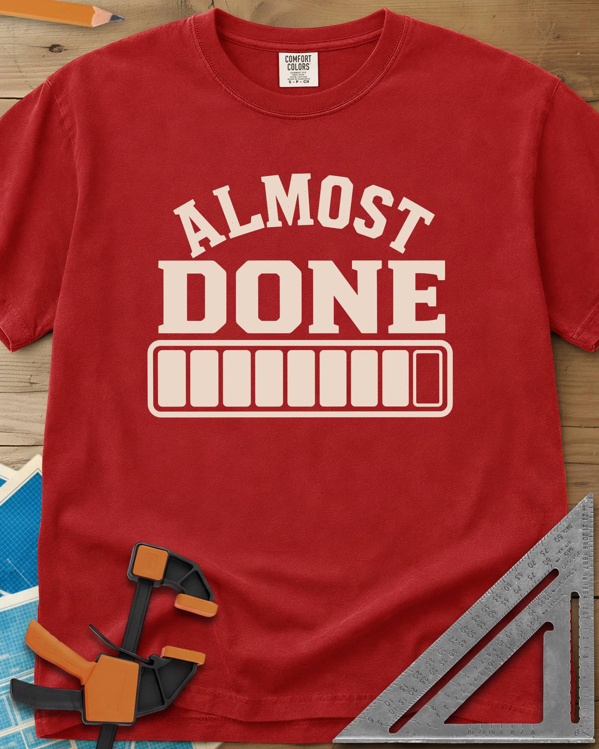 Almost Done heavyweight tee in Red, bold ALMOST DONE lettering over a nearly full loading bar