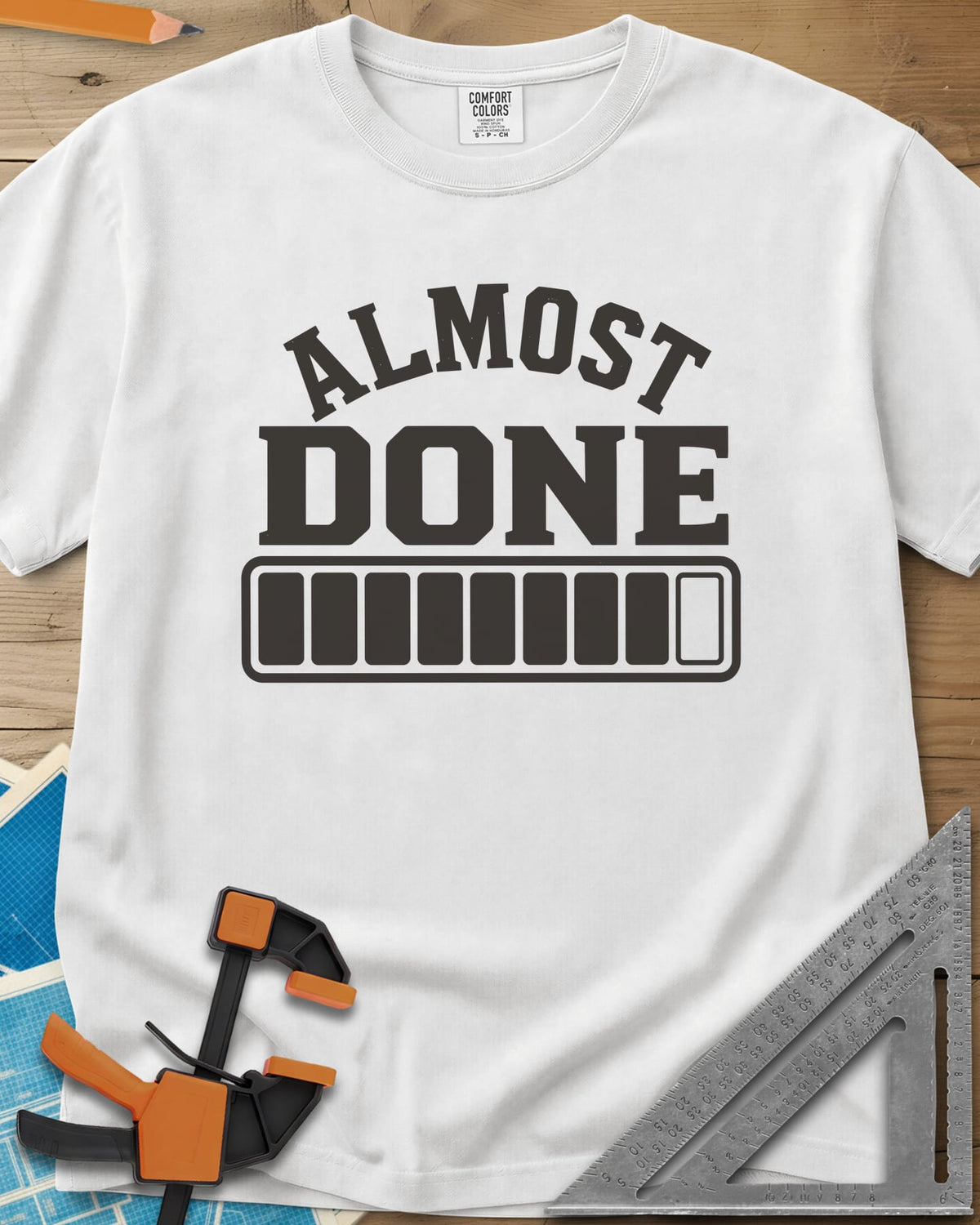 Almost Done heavyweight tee in White, bold ALMOST DONE lettering over a nearly full loading bar