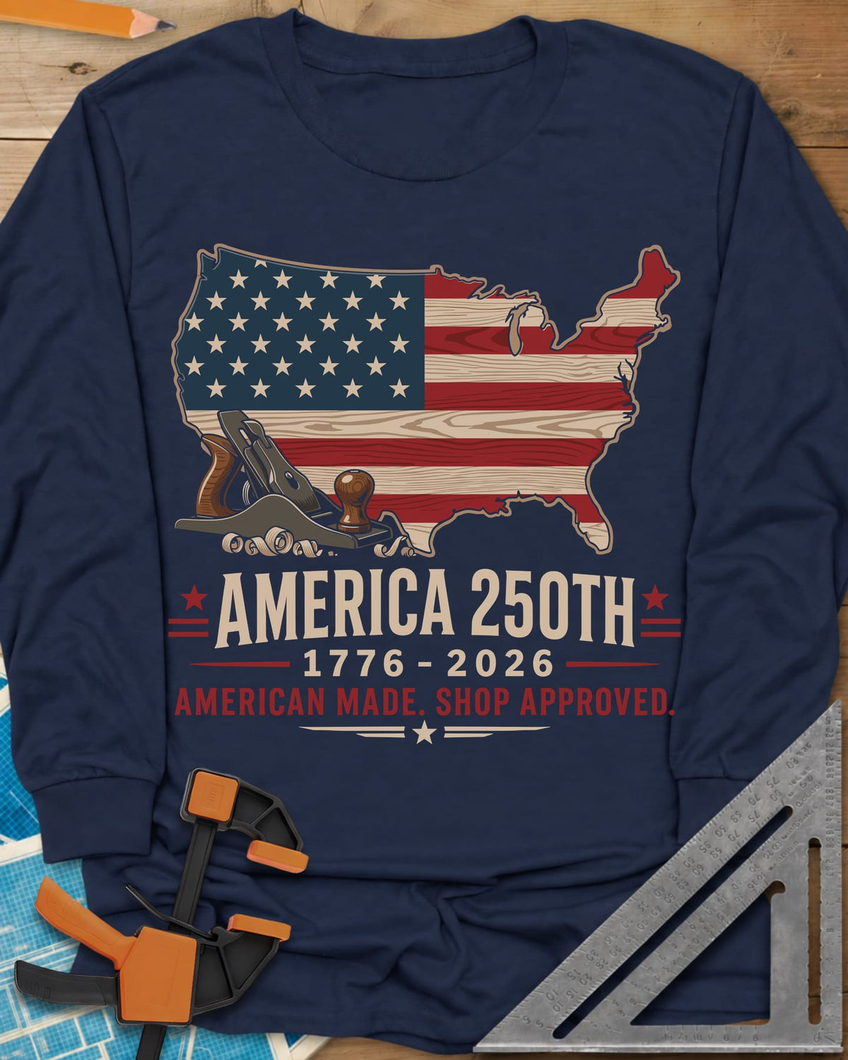 America 250th Shop Approved long sleeve shirt in Navy, a US map filled with a wood-plank flag, a hand plane and curls