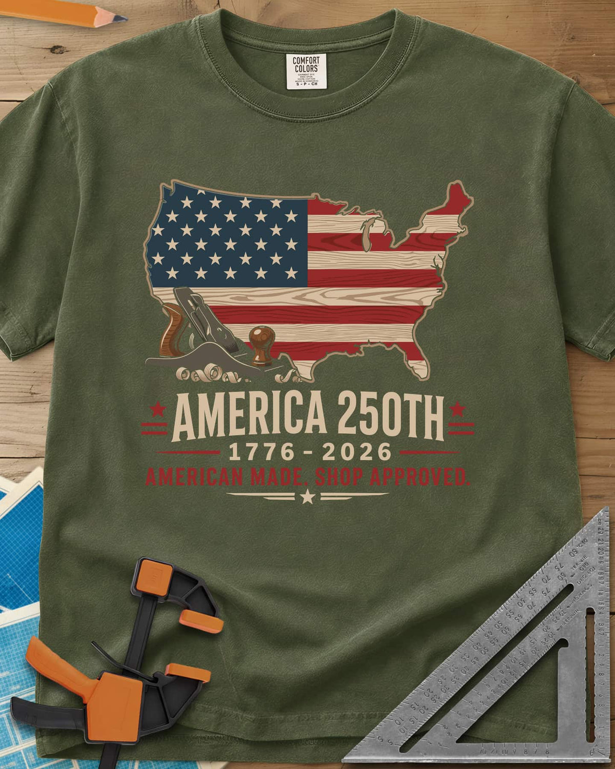 America 250th Shop Approved heavyweight tee in Hemp, a US map filled with a wood-plank flag, a hand plane and curls
