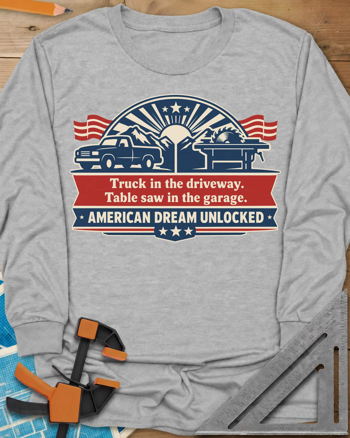 American Dream Unlocked long sleeve shirt in Sport Grey, a pickup and a table saw on a red and navy ribbon badge