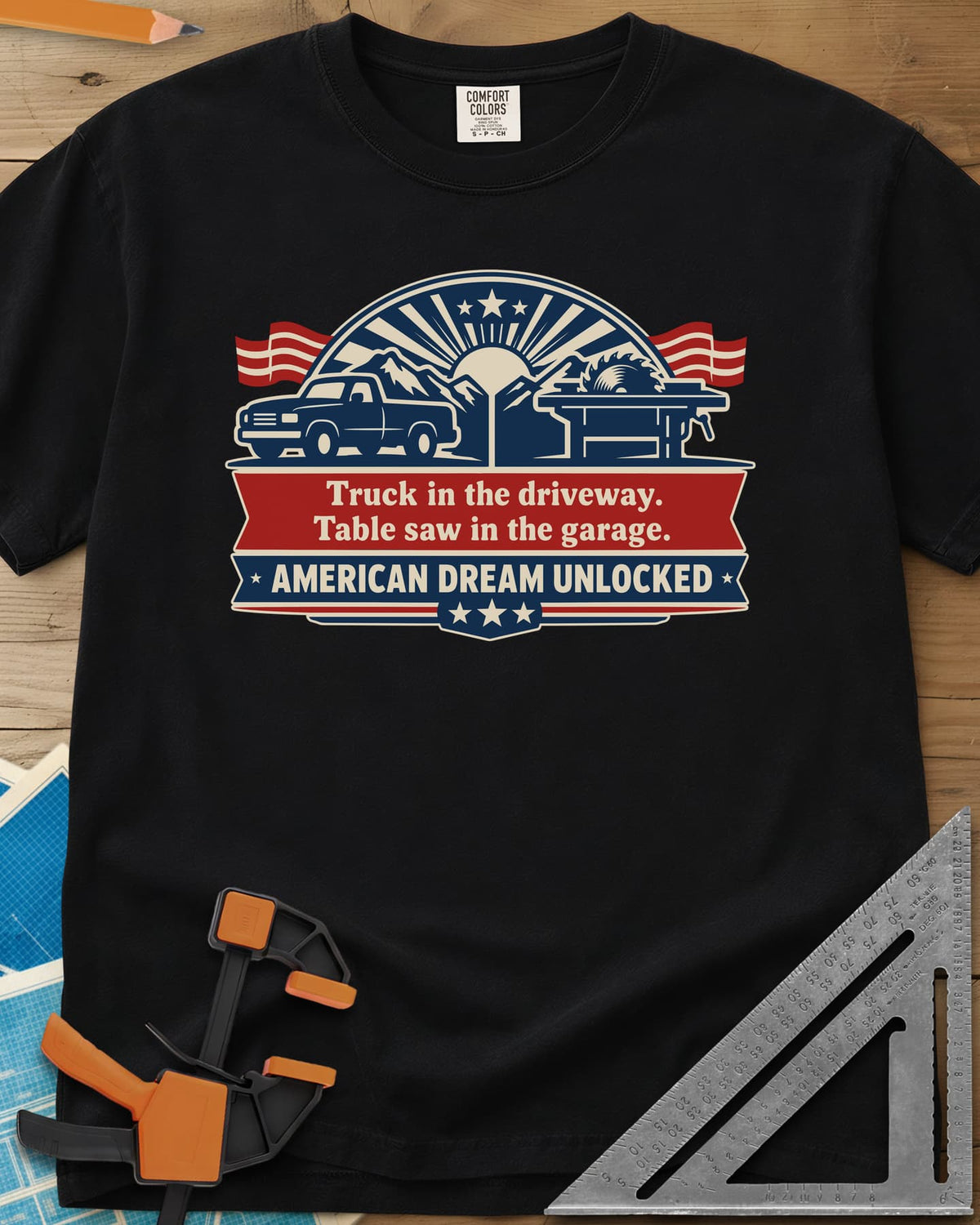 American Dream Unlocked heavyweight tee in Black, a pickup and a table saw on a red and navy ribbon badge