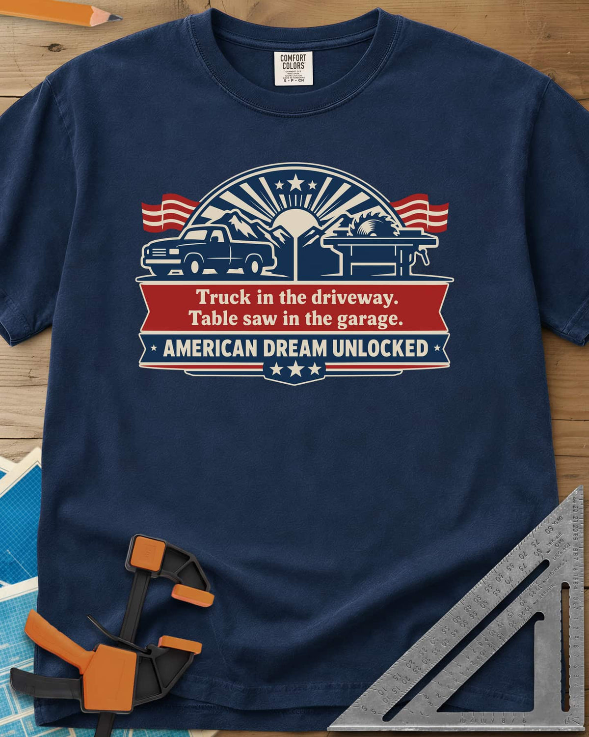 American Dream Unlocked heavyweight tee in Navy, a pickup and a table saw on a red and navy ribbon badge