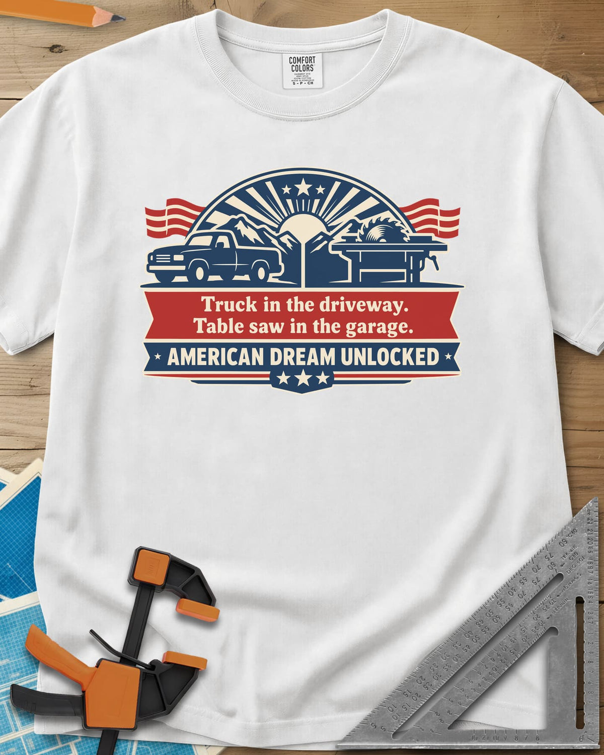 American Dream Unlocked heavyweight tee in White, a pickup and a table saw on a red and navy ribbon badge