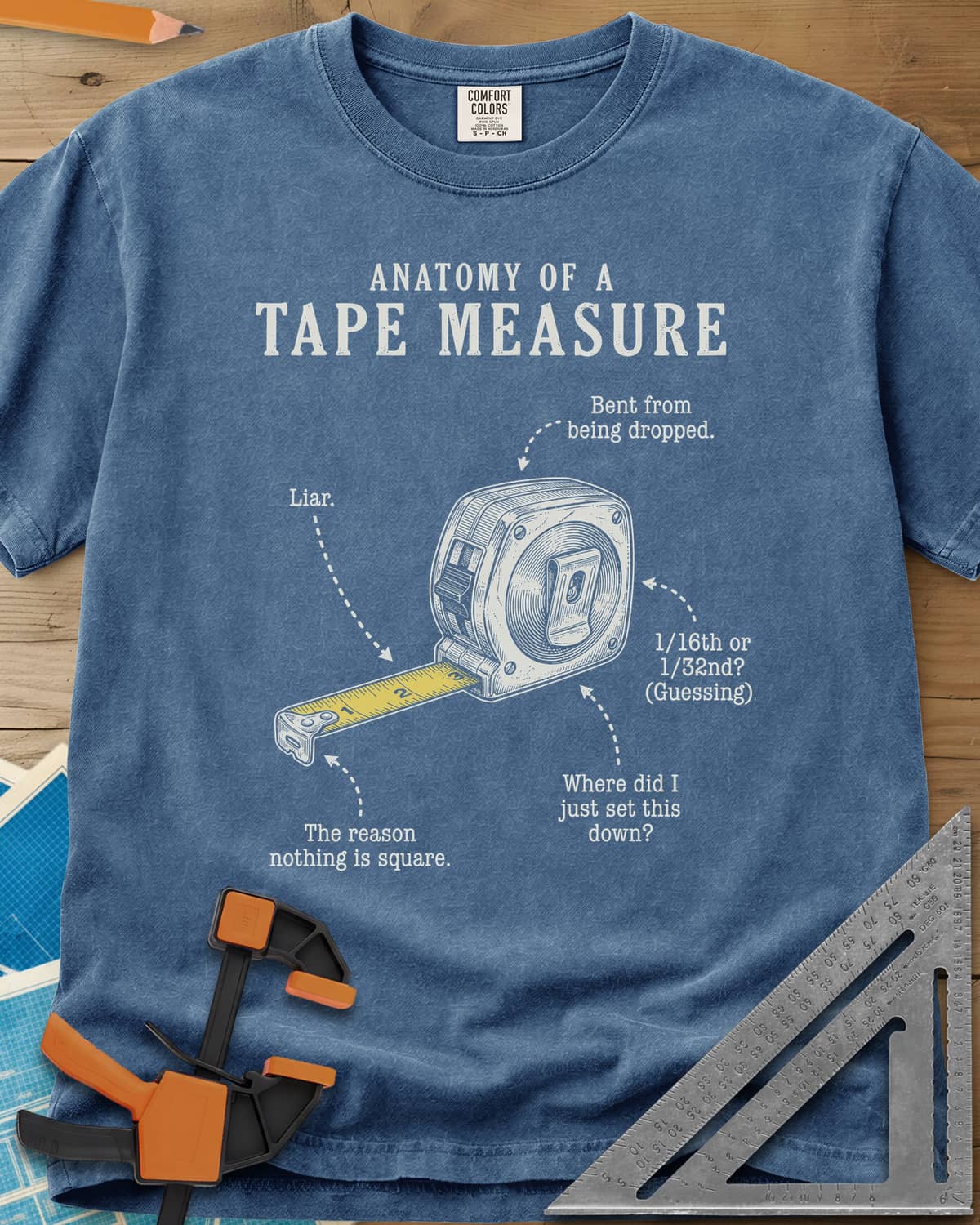 Anatomy of a Tape Measure heavyweight tee in Blue Jean, a tape measure diagram with joke labels on dotted arrows