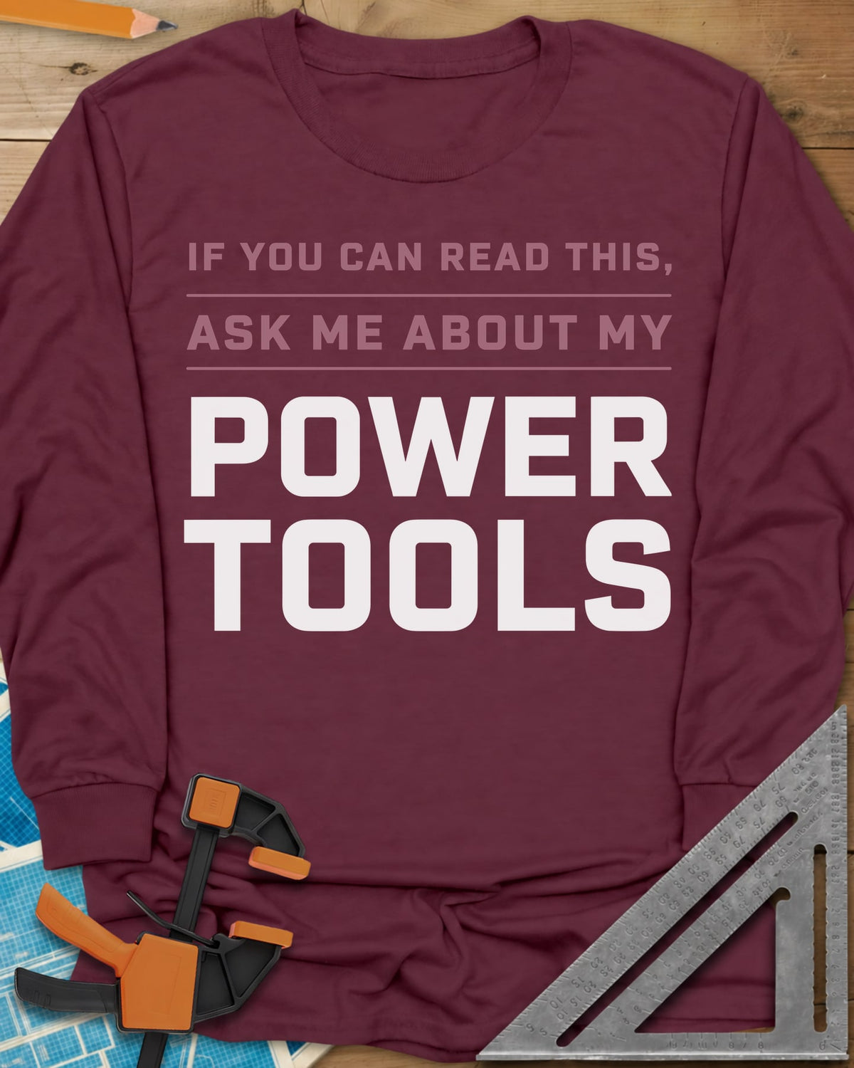 Ask Me About My Power Tools long sleeve shirt in Maroon, bold block type only, with POWER TOOLS in large letters