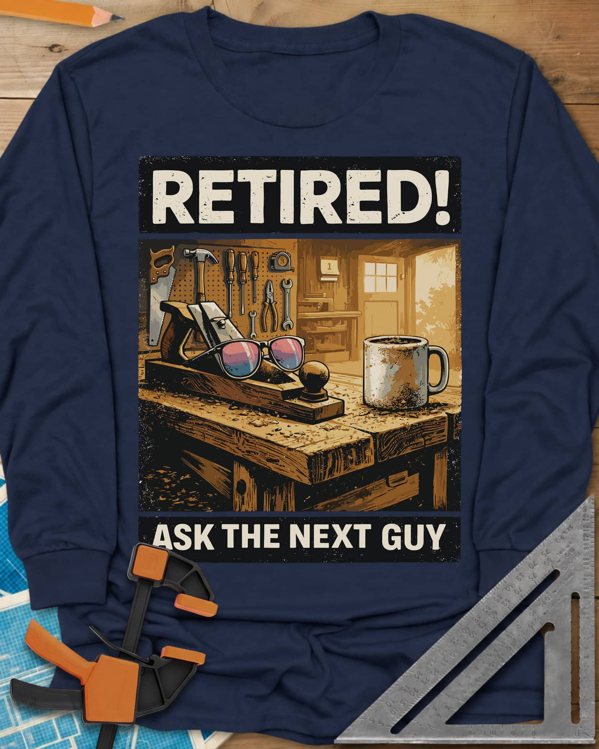 Ask The Next Guy long sleeve shirt in Navy, a sunlit workbench with a hand plane, sunglasses and a coffee mug