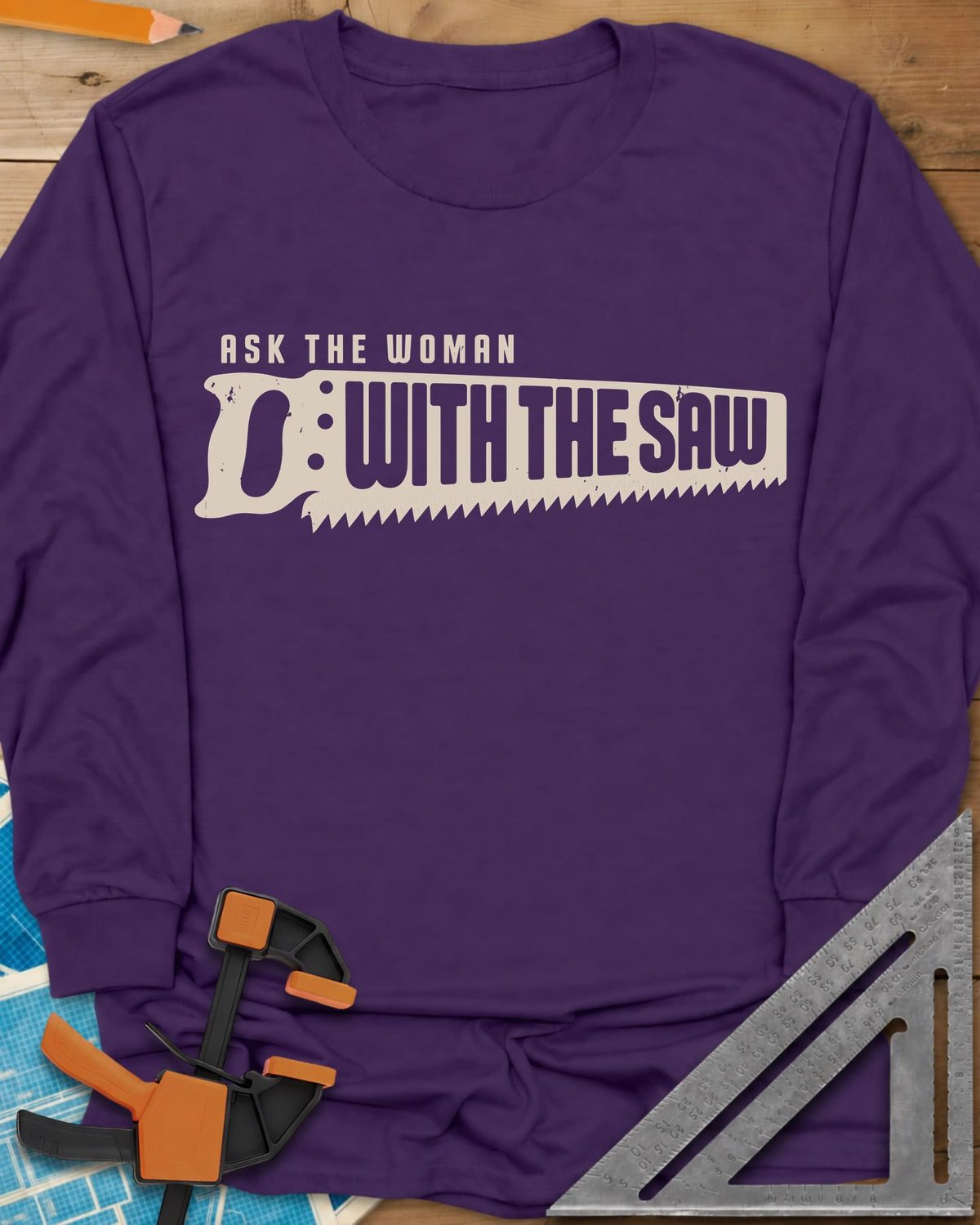 Ask The Saw long sleeve shirt in Purple, worn lettering inside a handsaw-shaped banner