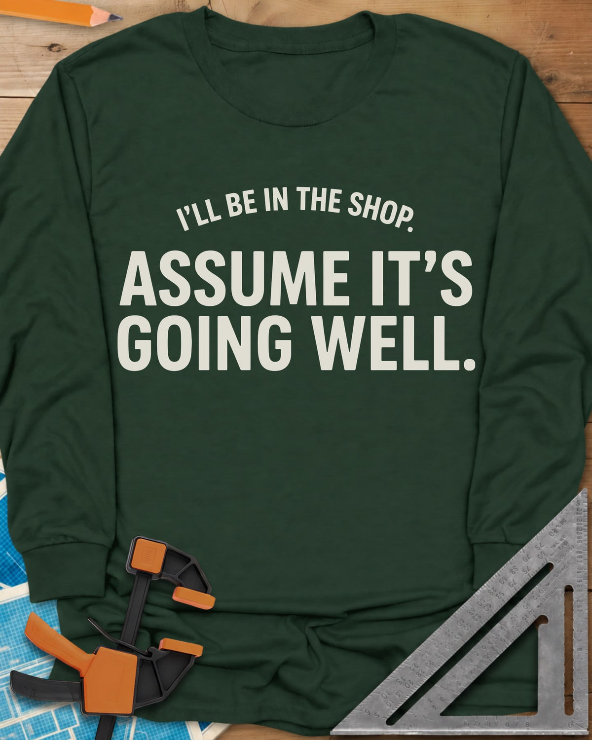 Assume It's Going Well long sleeve shirt in Forest Green, bold two-line lettering with a small arched line above