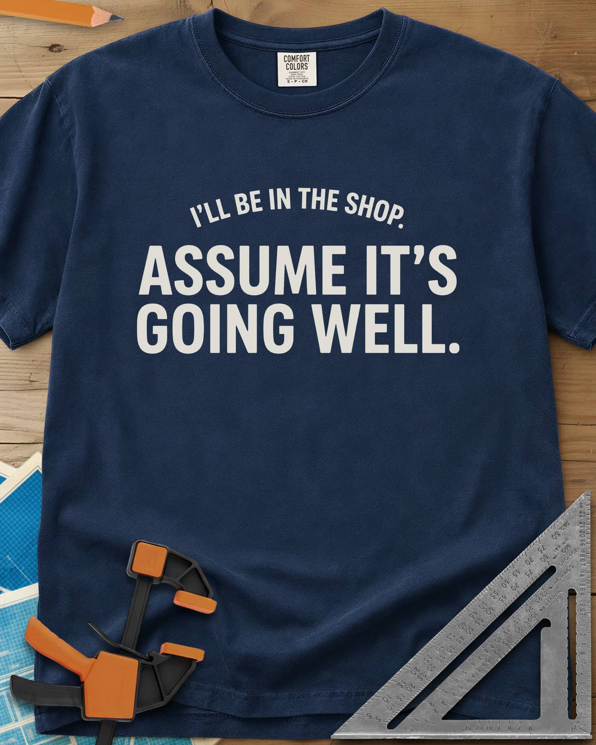 Assume It's Going Well heavyweight tee in Navy, bold two-line lettering with a small arched line above