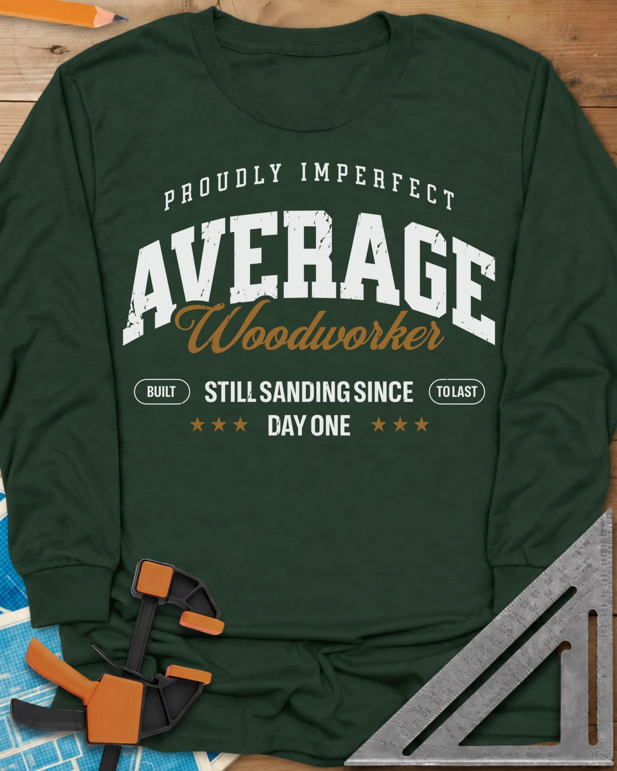 Average Woodworker long sleeve shirt in Forest Green, varsity AVERAGE over gold script Woodworker, with badges and stars