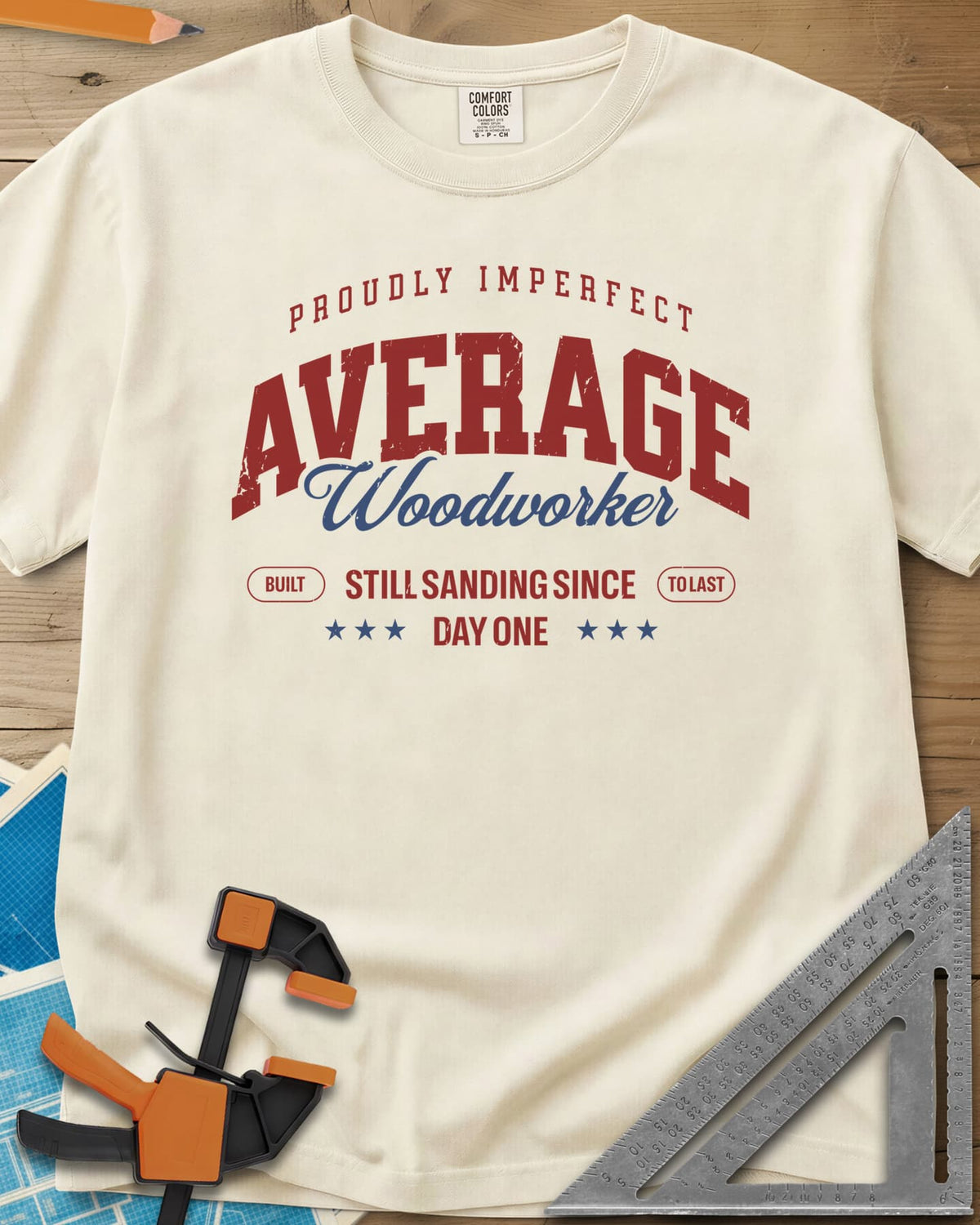Average Woodworker heavyweight tee in Ivory, varsity AVERAGE over gold script Woodworker, with badges and stars