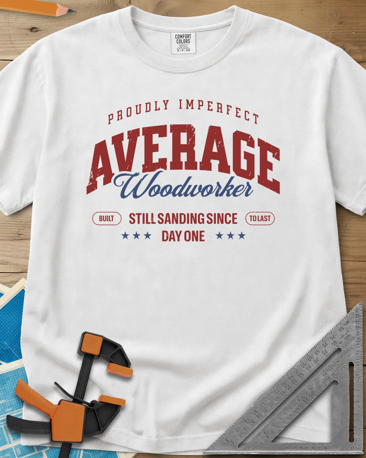 Average Woodworker heavyweight tee in White, varsity AVERAGE over gold script Woodworker, with badges and stars
