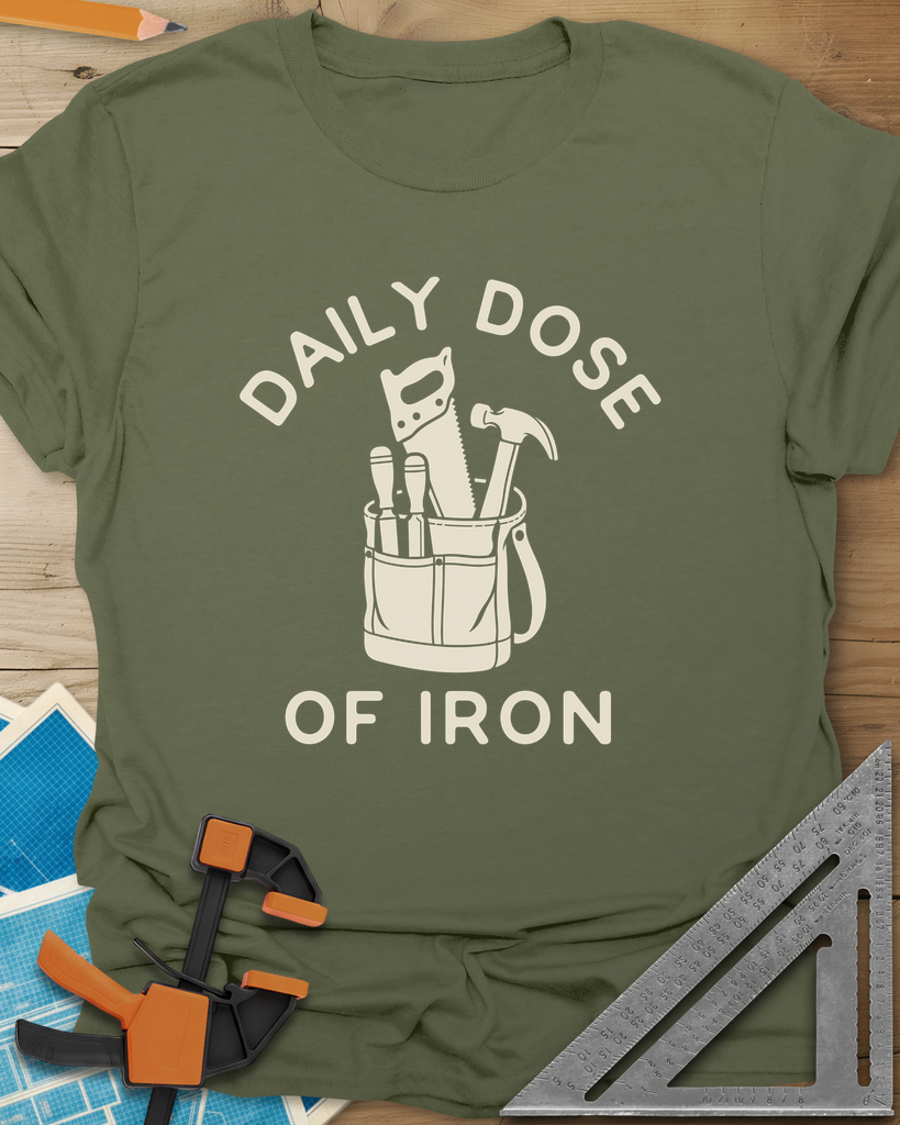 Daily Dose t-shirt in Military Green, a canvas tool bag holding a handsaw, hammer and two chisels