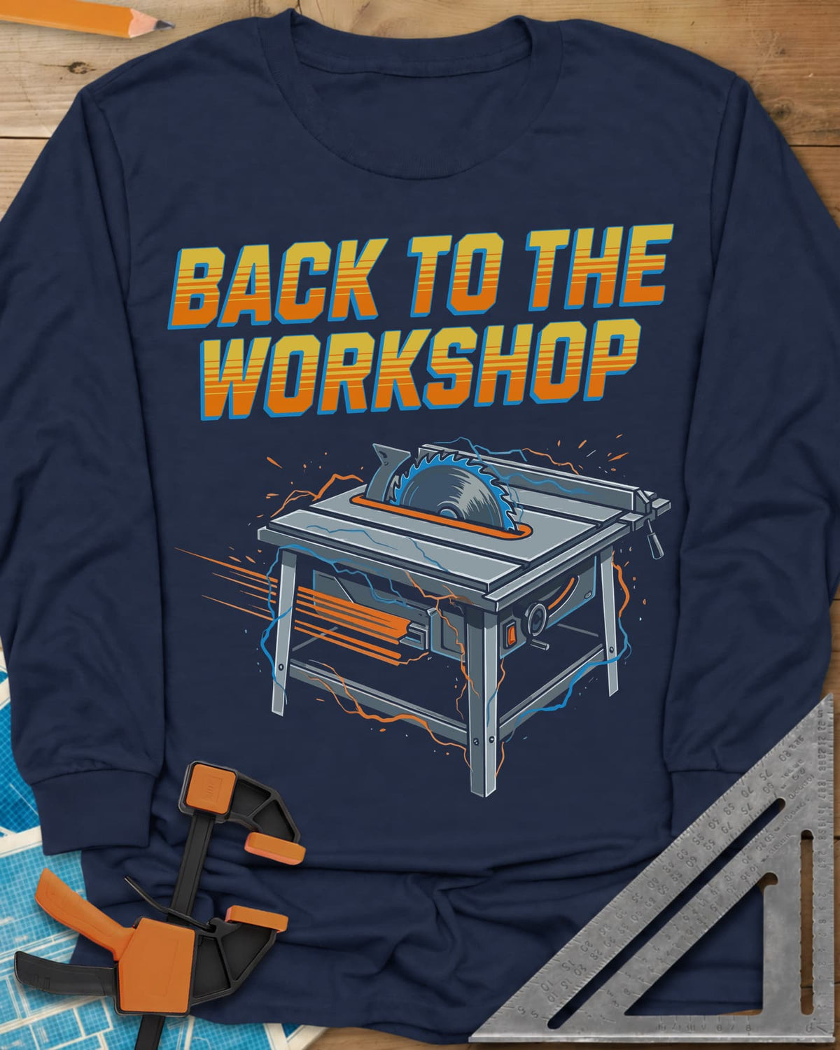 Back To The Workshop long sleeve shirt in Navy, a table saw crackling with blue electricity and speed streaks