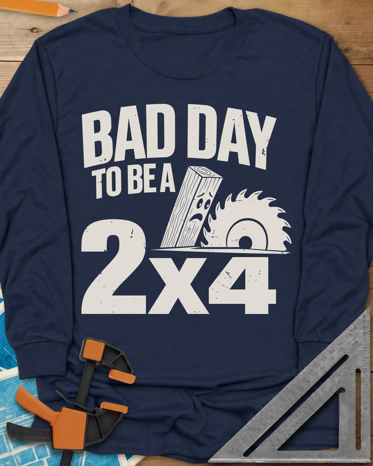 Bad Day 2x4 long sleeve shirt in Navy, a 2x4 board with a worried face beside a circular saw blade