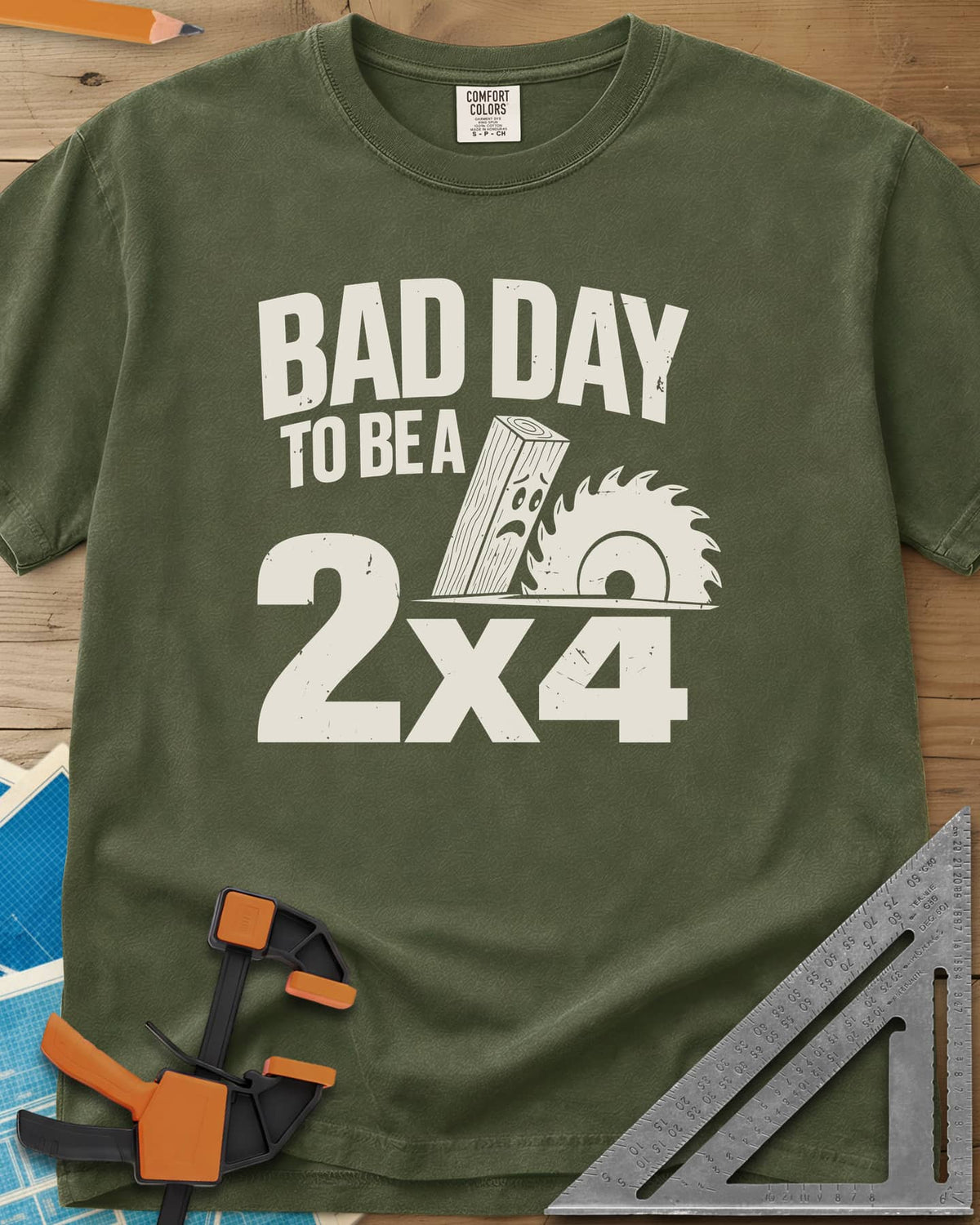 Bad Day 2x4 heavyweight tee in Hemp, a 2x4 board with a worried face beside a circular saw blade