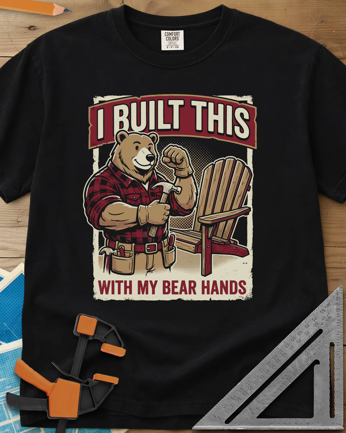 Bear Hands heavyweight tee in Black, a flannel bear with hammer and tool belt beside an Adirondack chair