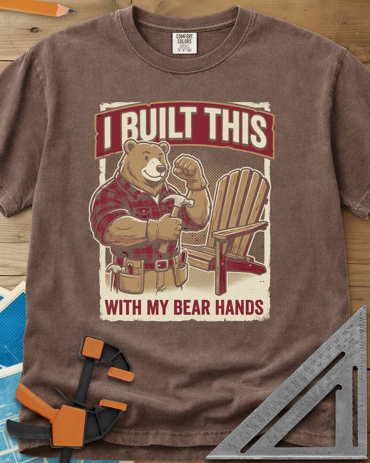 Bear Hands heavyweight tee in Espresso, a flannel bear with hammer and tool belt beside an Adirondack chair