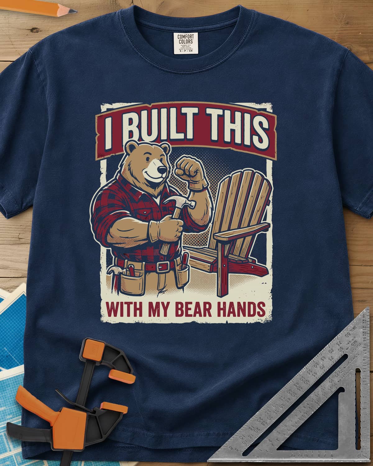 Bear Hands heavyweight tee in Navy, a flannel bear with hammer and tool belt beside an Adirondack chair