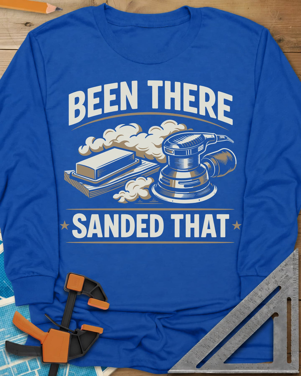 Been There Sanded That long sleeve shirt in Royal, a random orbital sander and sanding block in clouds of dust