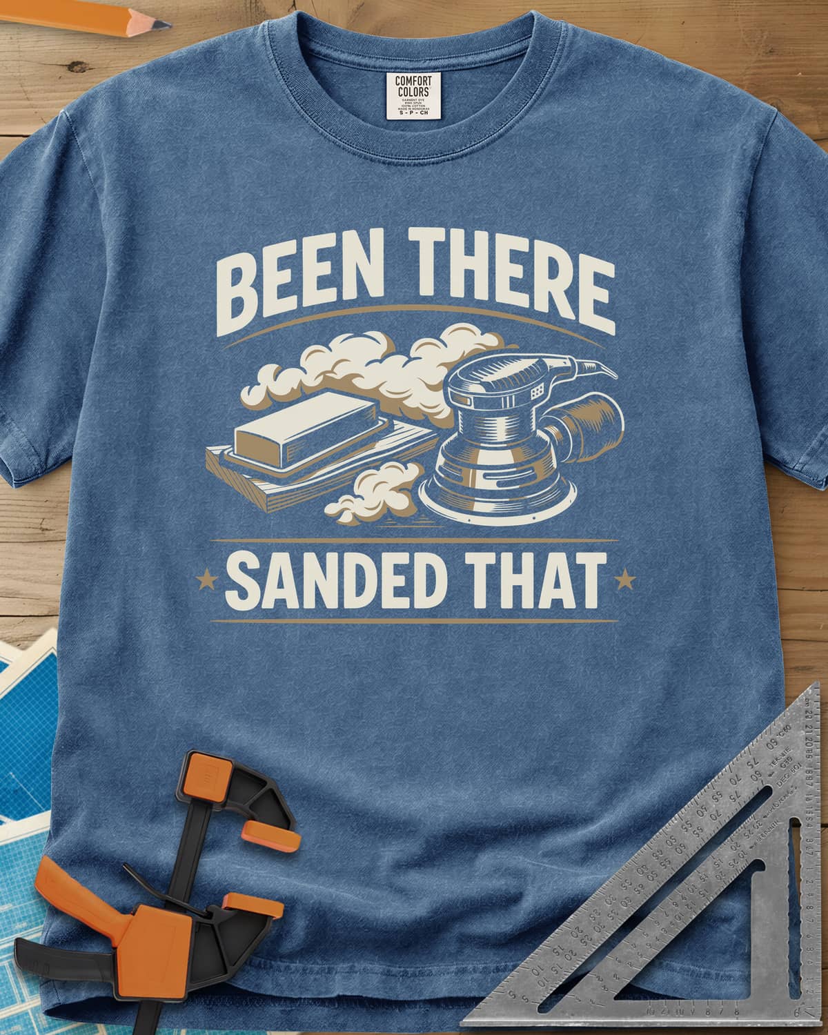 Been There Sanded That heavyweight tee in Blue Jean, a random orbital sander and sanding block in clouds of dust