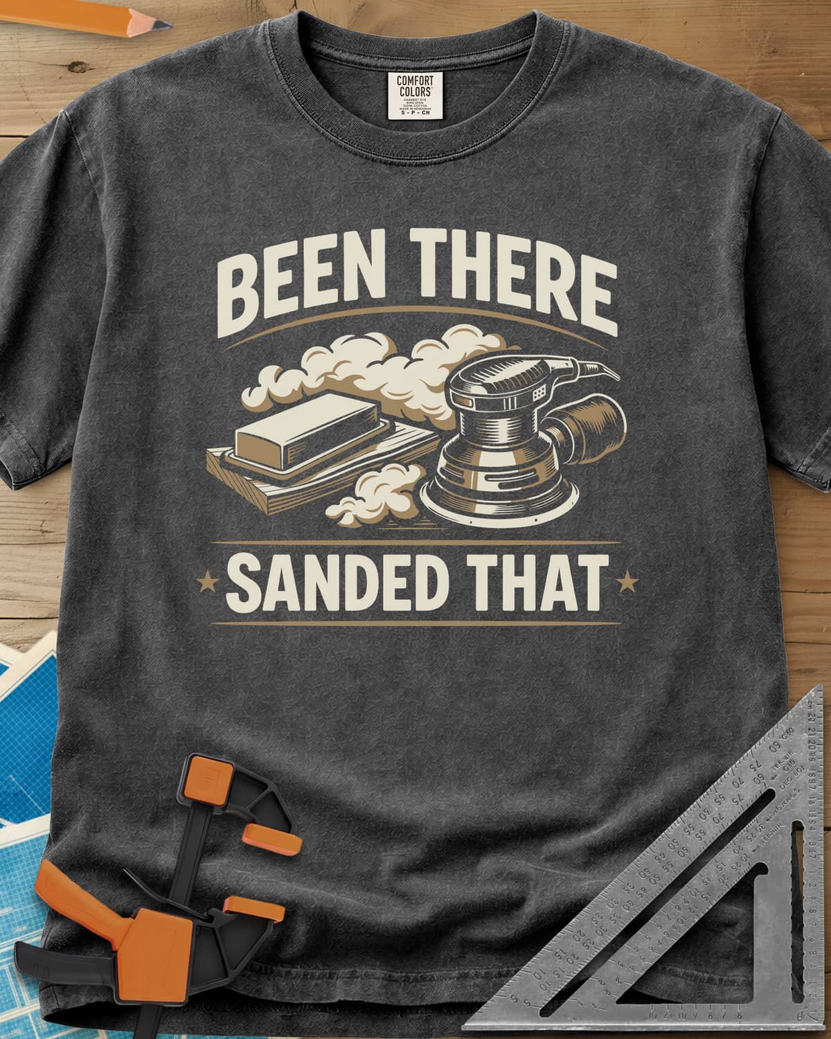 Been There Sanded That heavyweight tee in Pepper, a random orbital sander and sanding block in clouds of dust