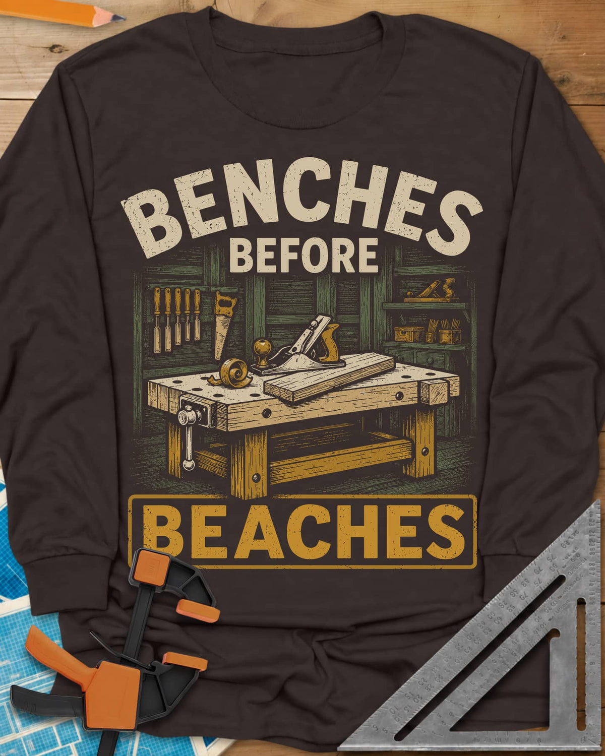 Benches Before Beaches long sleeve shirt in Dark Chocolate, a woodworking bench with a hand plane, chisels and a saw on the